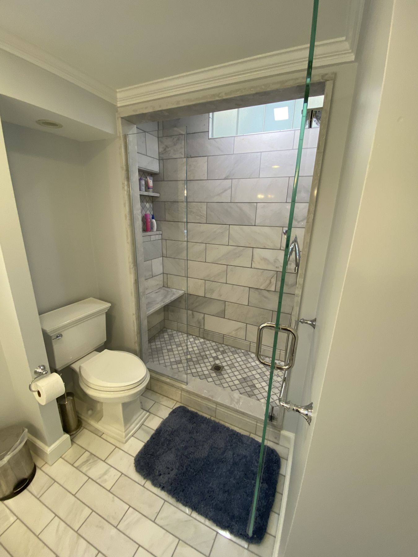 Bathroom with a marble tile floor and walk-in shower