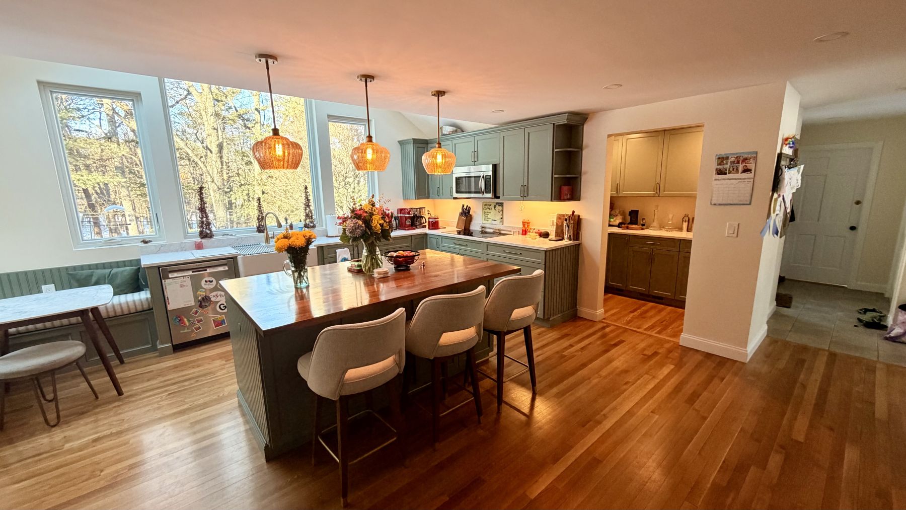 Kitchen island with pendant lighting open to the dining room