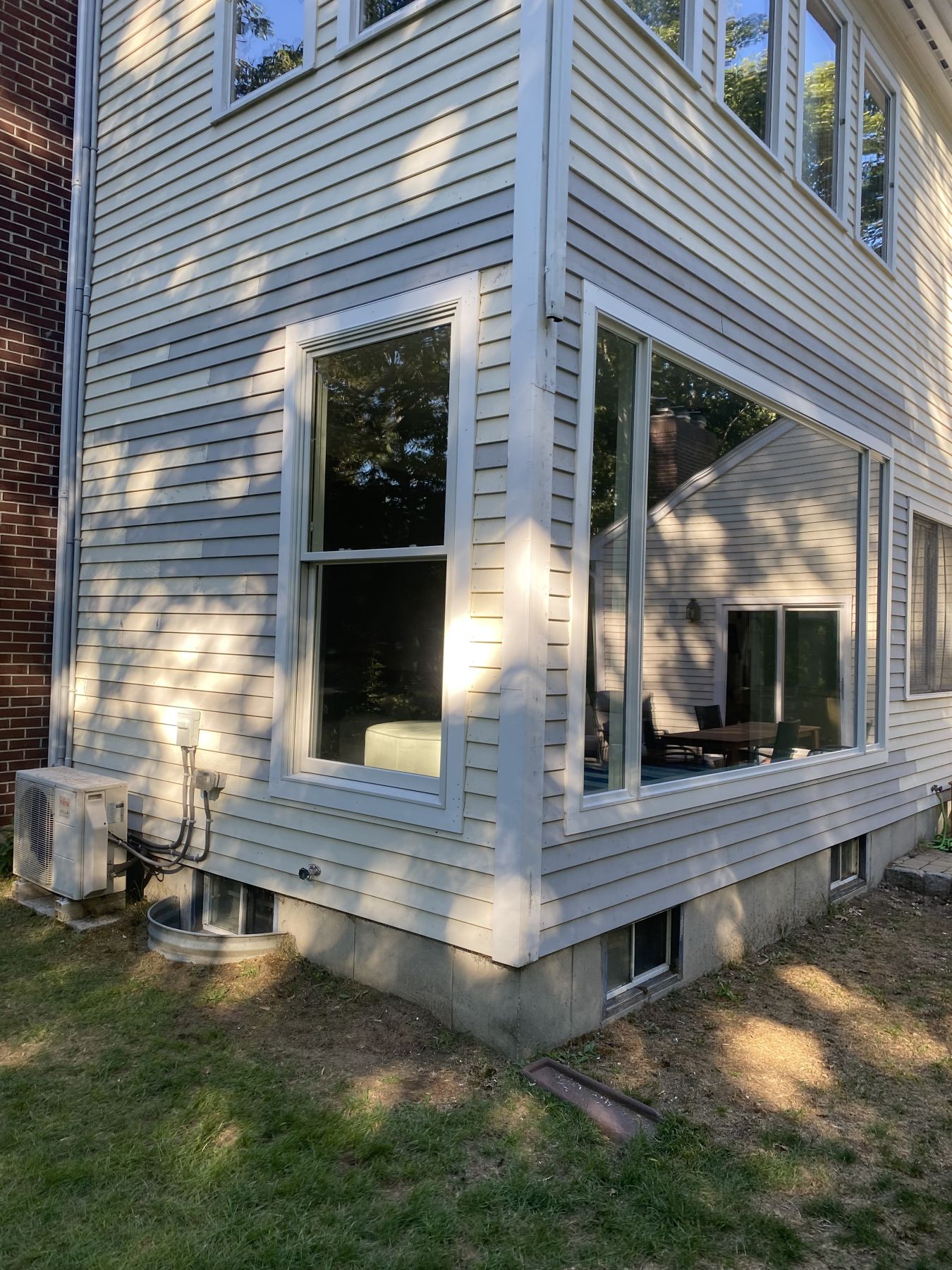 Replacement picture and double-hung windows in a clapboard wall